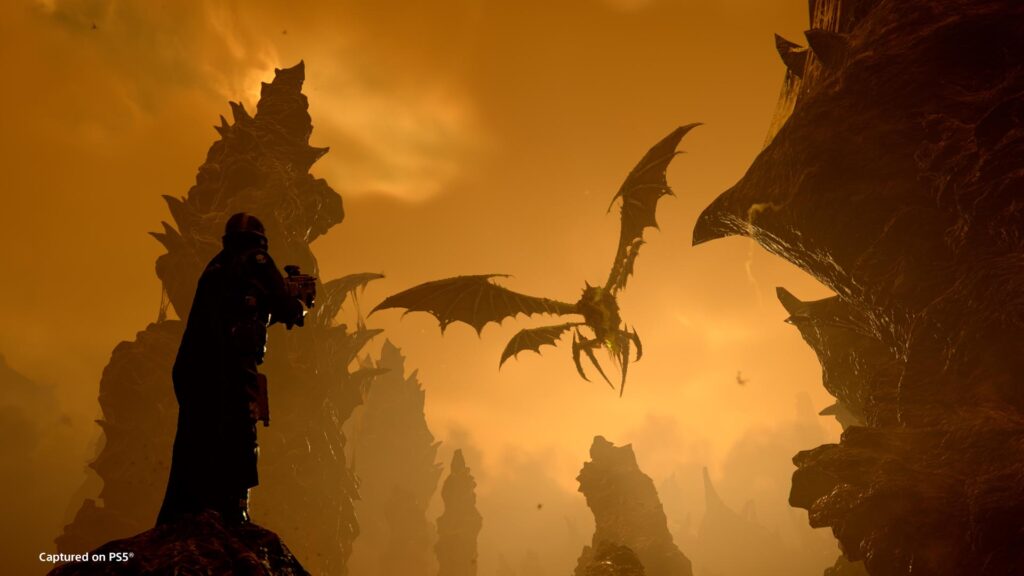 Helldiver aiming at a flying Terminid on a Hive world — orange sky, hostile spires